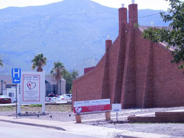 A church with a large red brick wall.