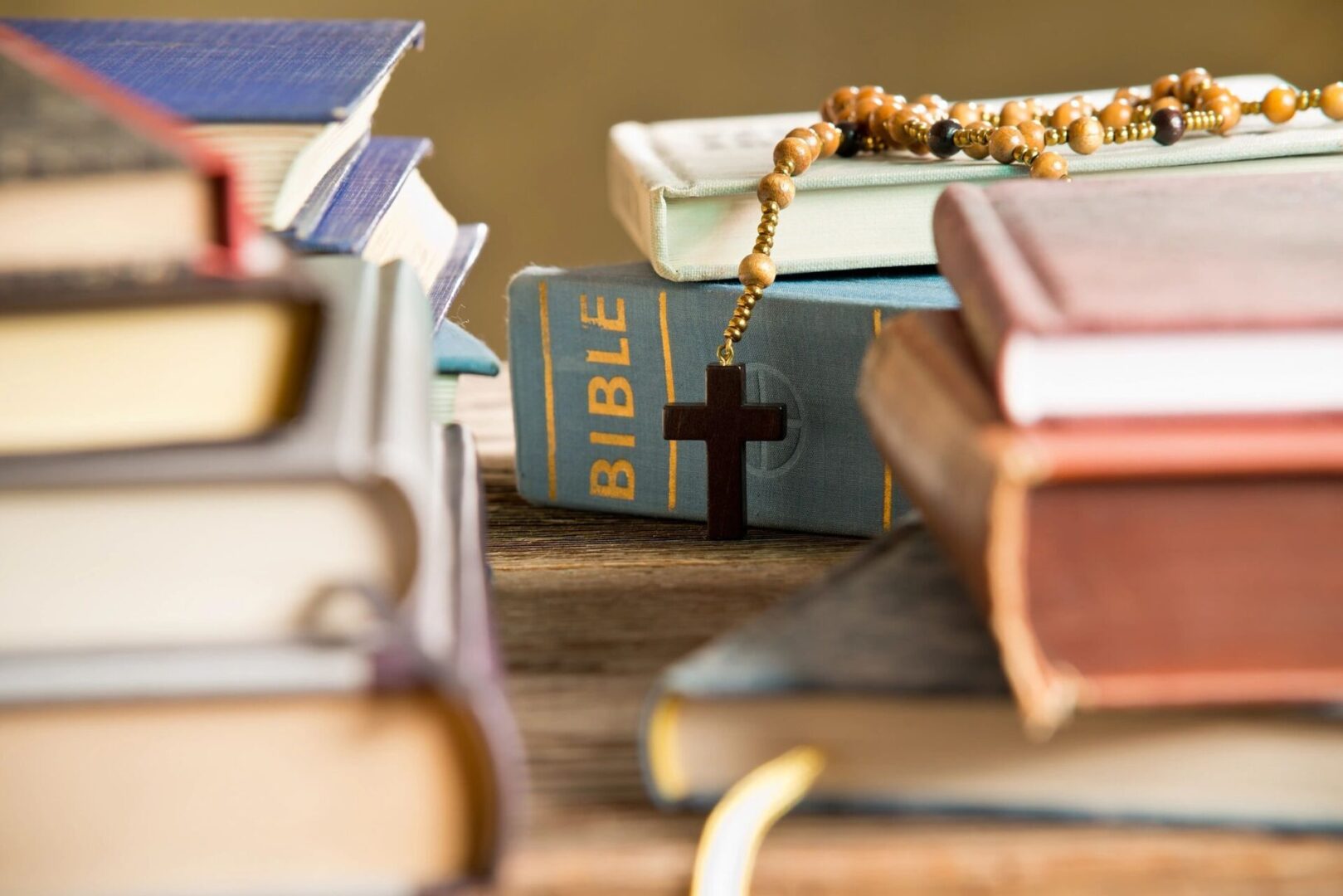 A table with many books and a cross on it